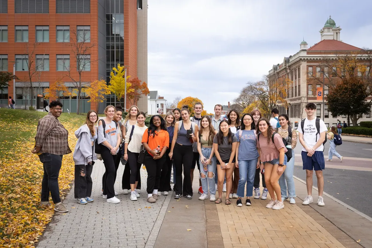 Students on a street in downtown Syracuse.